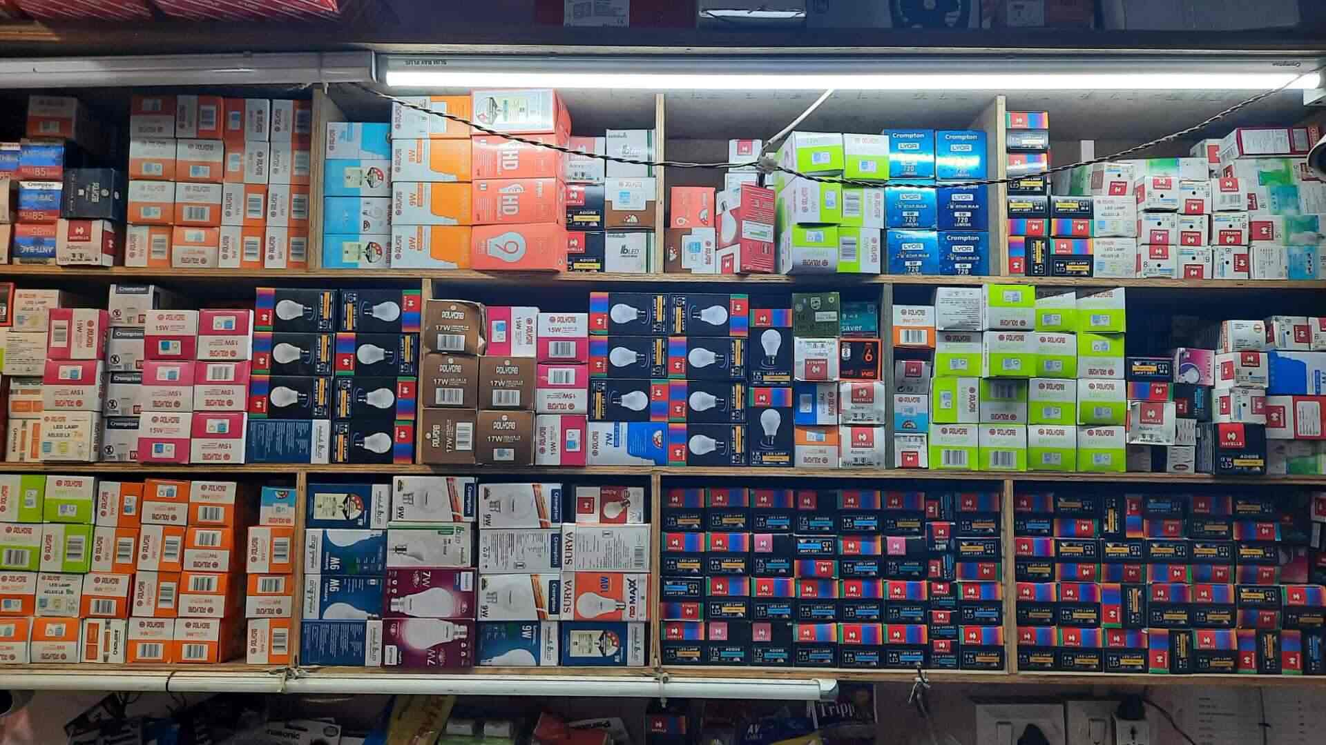 Boxed lighting and electrical goods on shelves inside RRR Electricals