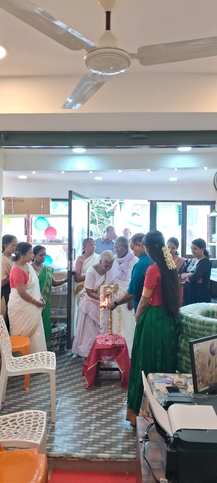 The traditional lamp-lighting ceremony inside RRR Traders at its opening